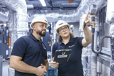 Two Leadec employees inspecting thermal power station.